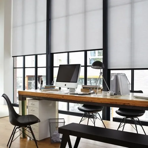 White roller blinds in a bright home office